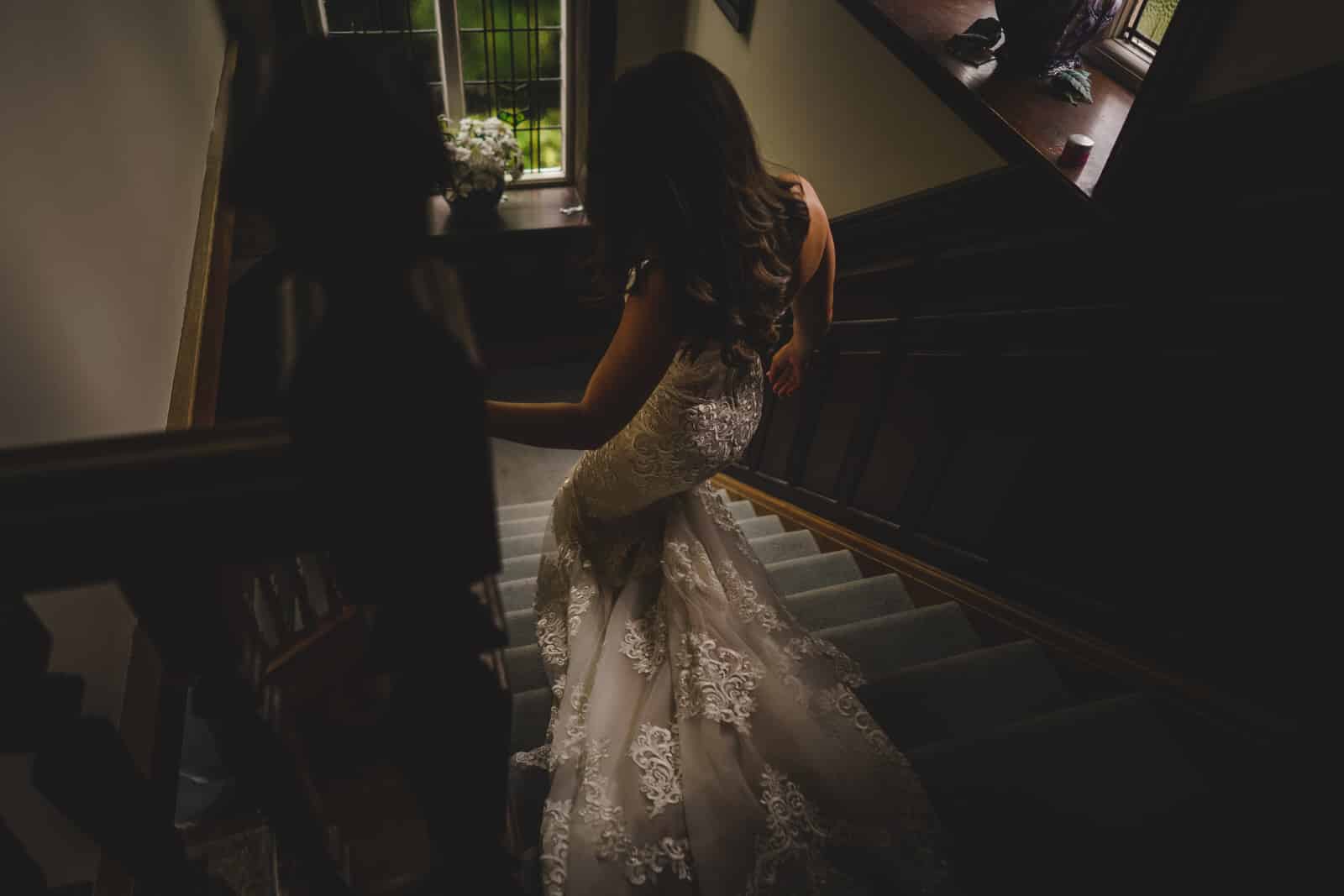 the bride makes her way down the stairs 